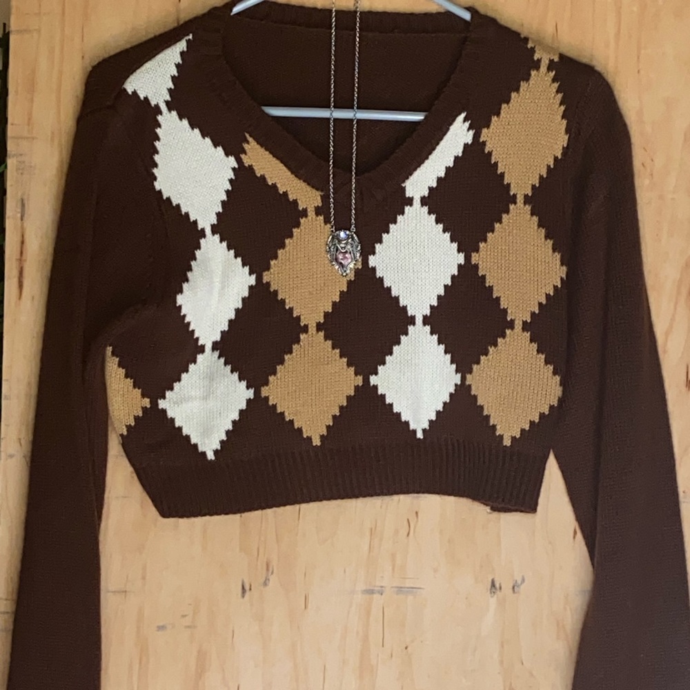 brown hoodie with a necklace